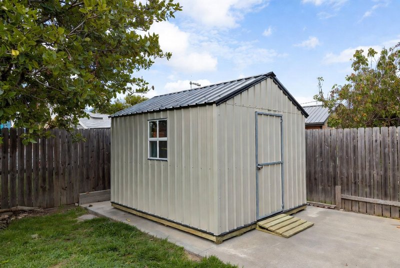 Metal storage shed in backyard